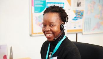 Smiling nurse wearing a call centre headset