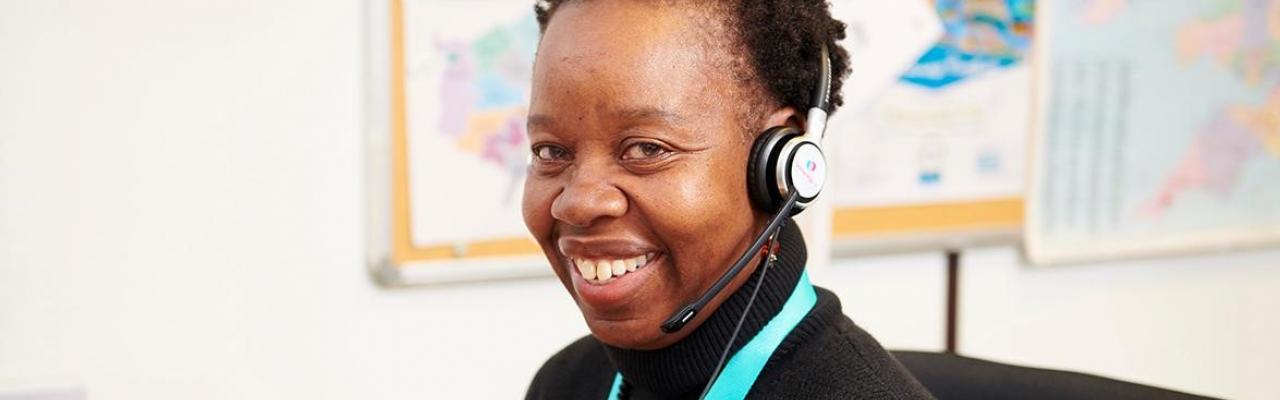 Smiling nurse wearing a call centre headset