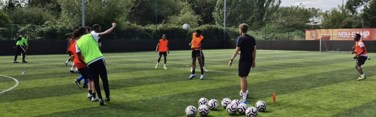 Boys at football practice on grass pitch