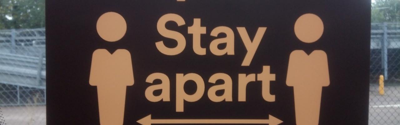 stay safe stay apart road sign