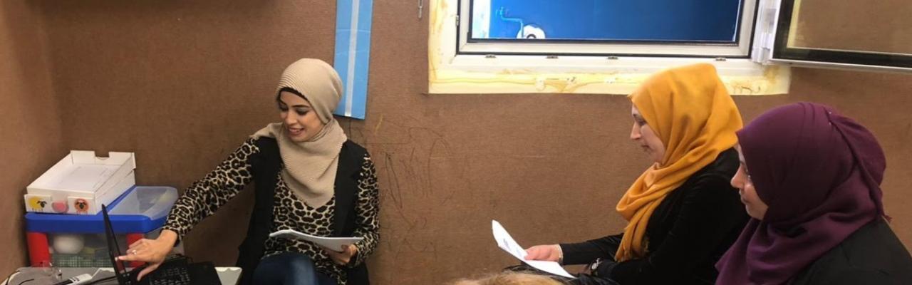 3 Arab women sitting in a classroom